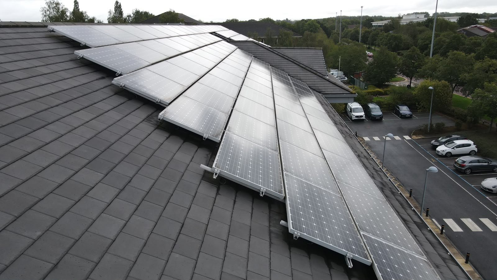 Solar array on a dark tiled roof, photographed from above
